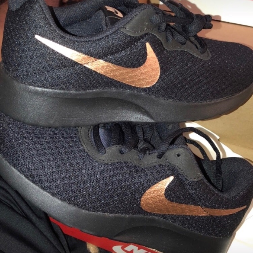 Black and rose gold Nike Tanjun